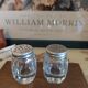 Antique salt and pepper shakers in crystal and silver metal.