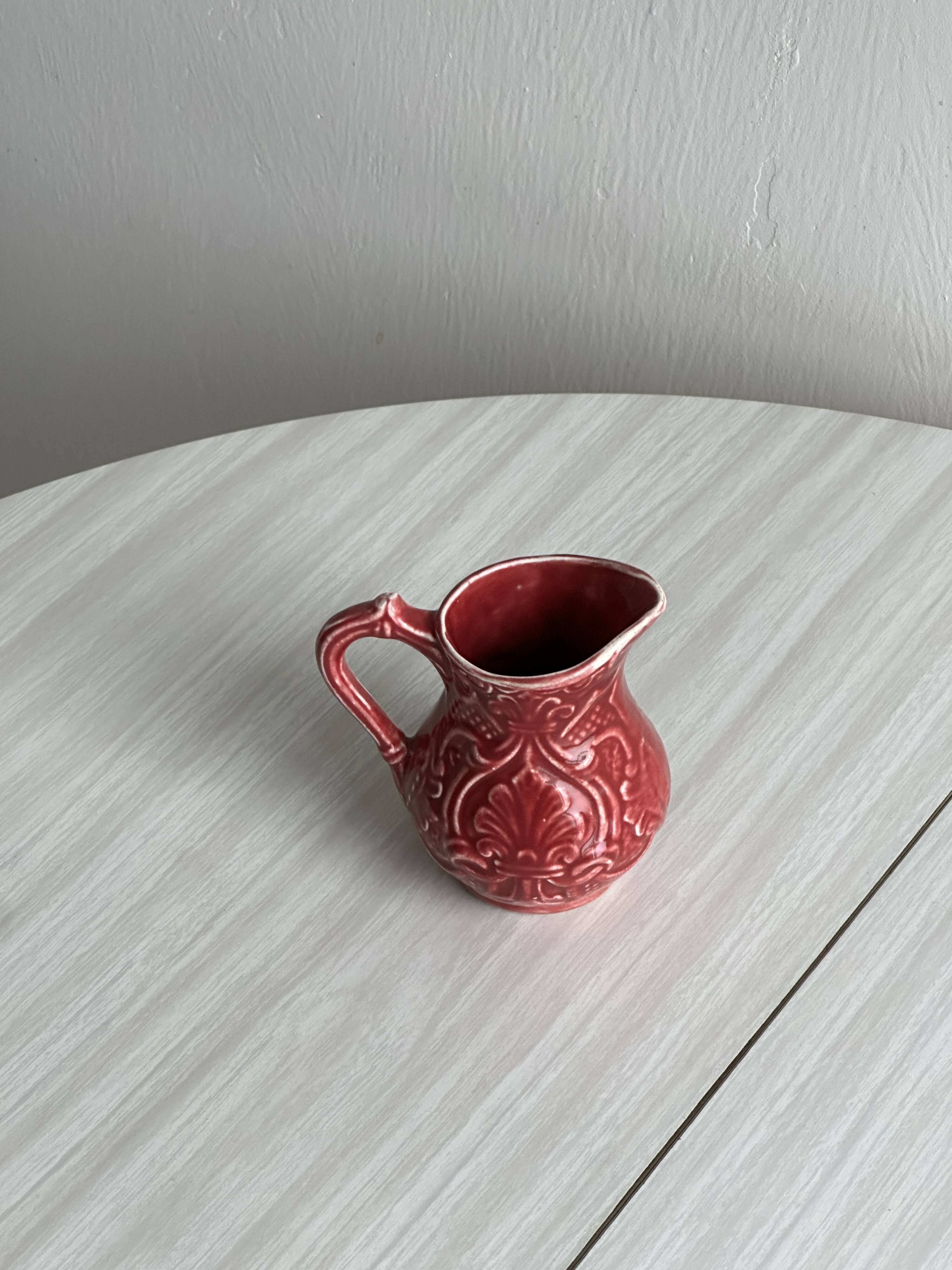Red ceramic milk jug