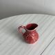 Red ceramic milk jug