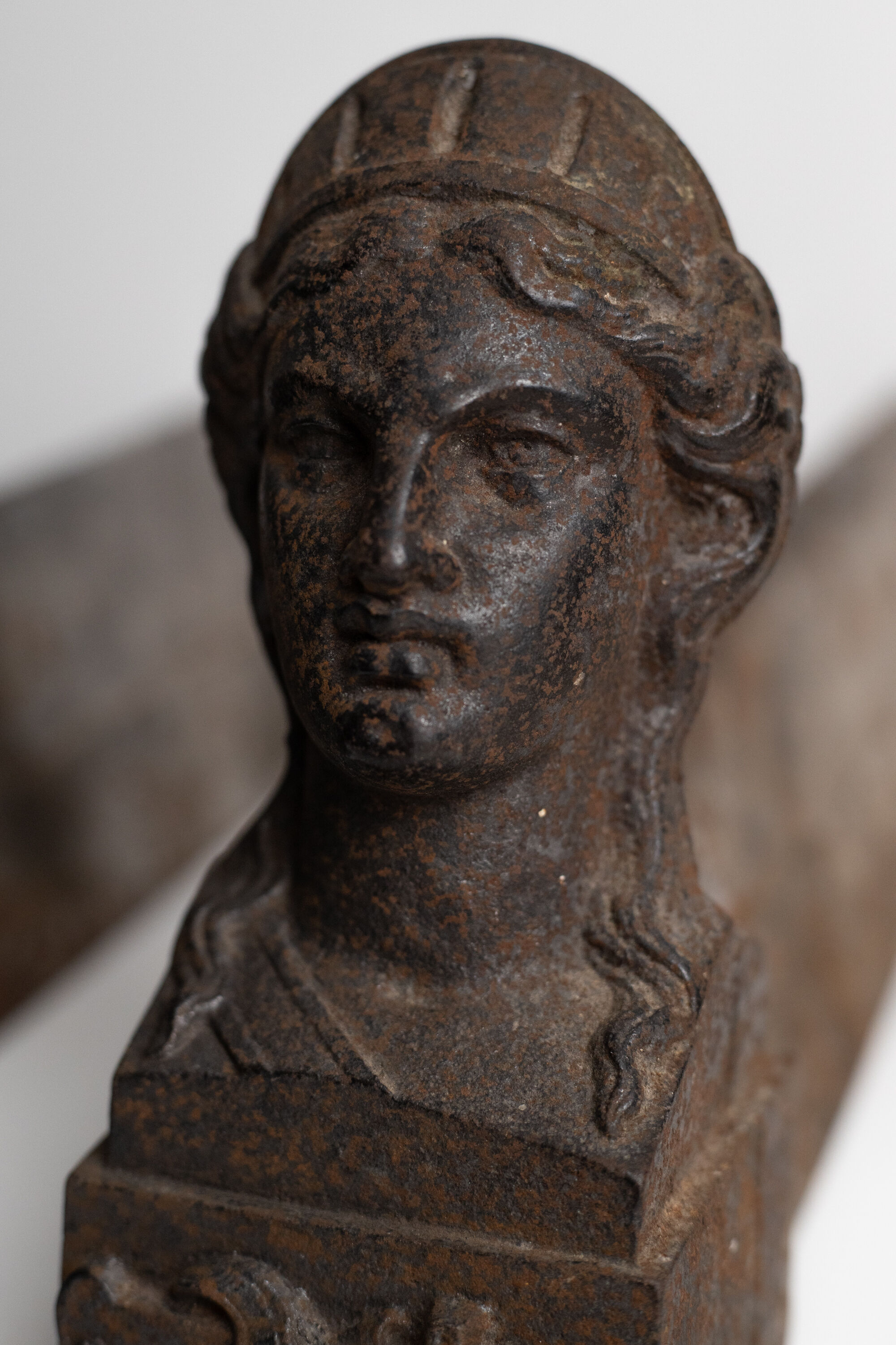 Pair of ancient cast iron chenets adorned with bust of Marianne