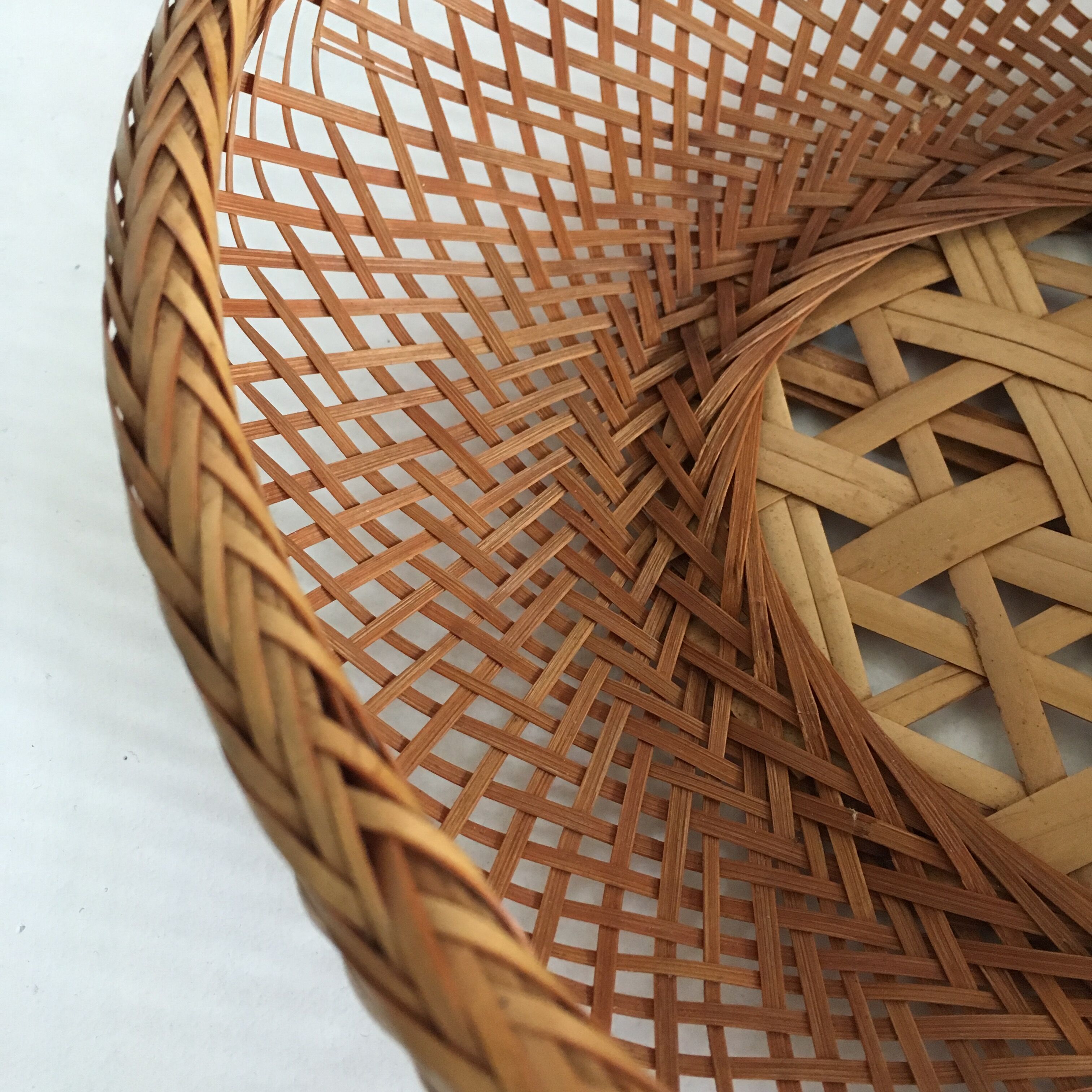 Braces of wood and woven rattan oval basket