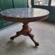 Round pedestal table with marble top and mahogany tripod from the 19th century