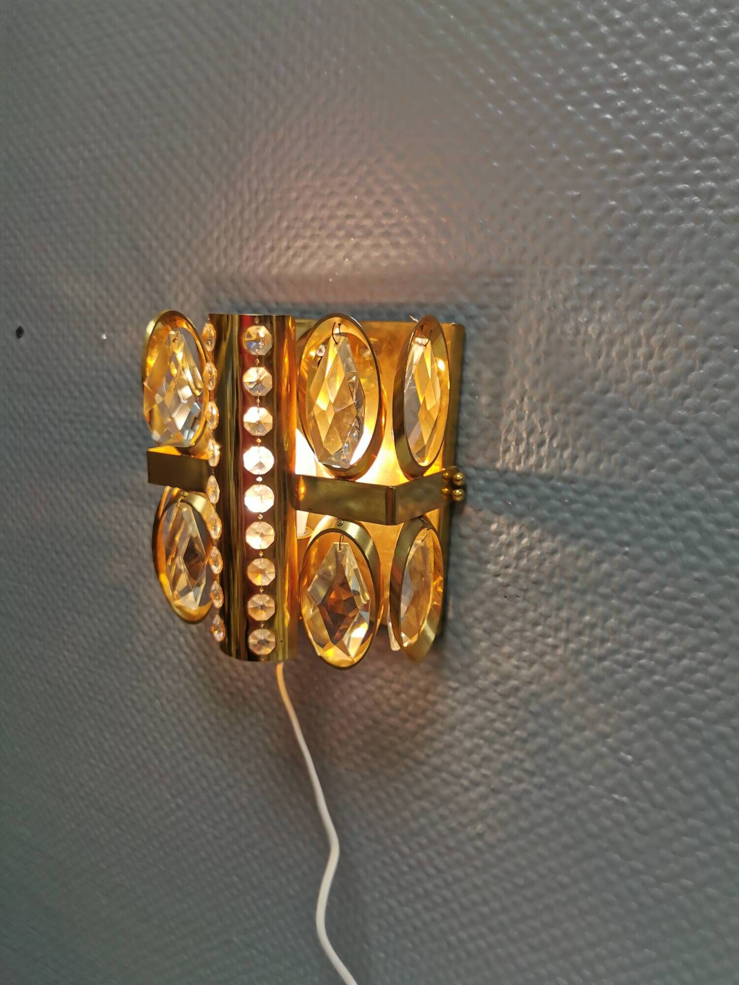 Swedish wall lamp in gold-colored metal with glass prisms. Estimated 1970-80s.