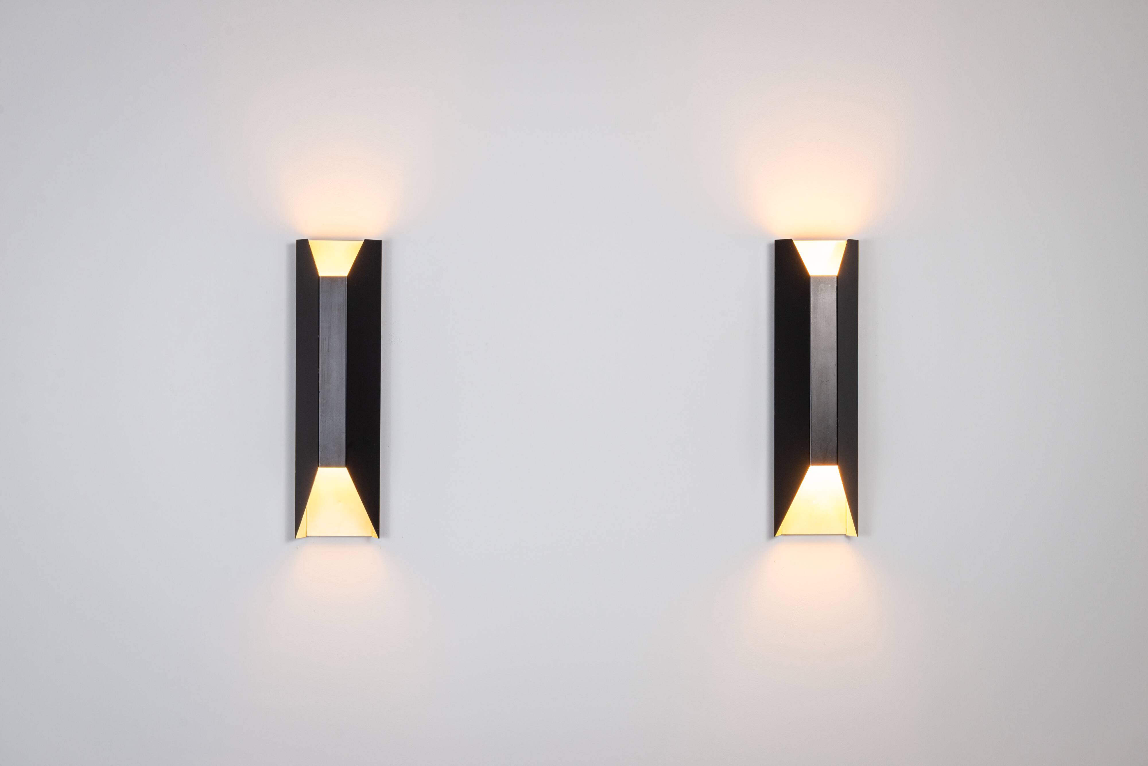 Architectural pair of vintage black metal wall lamps with angular geometric