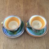 Two cups and their hand-painted ceramic saucer