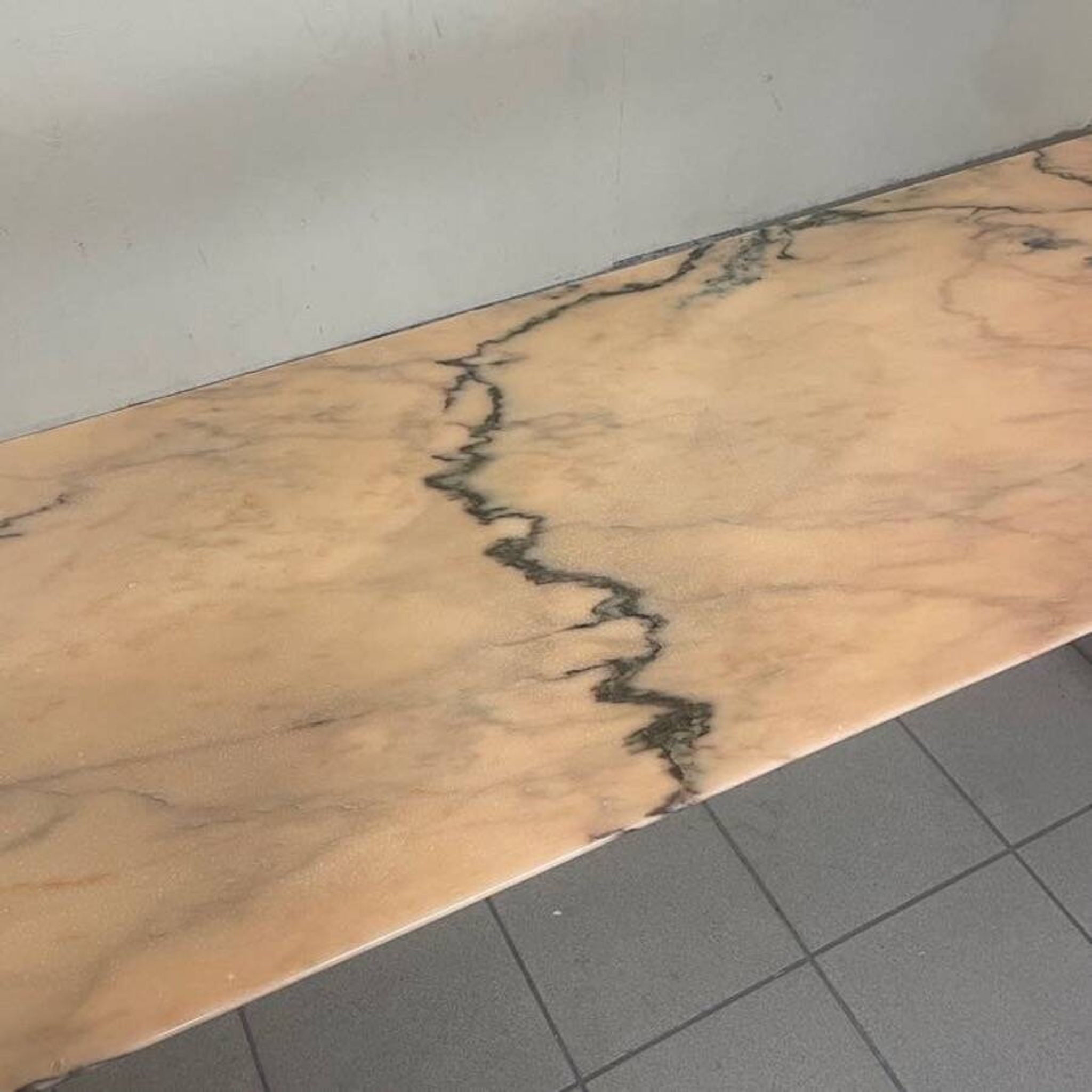 Console from the 1950s with a pink marble top and a cherry wood frame.