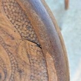 pair of round wooden chairs with a pattern on the seat
