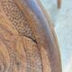 pair of round wooden chairs with a pattern on the seat