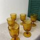 Six amber-colored stemmed glasses