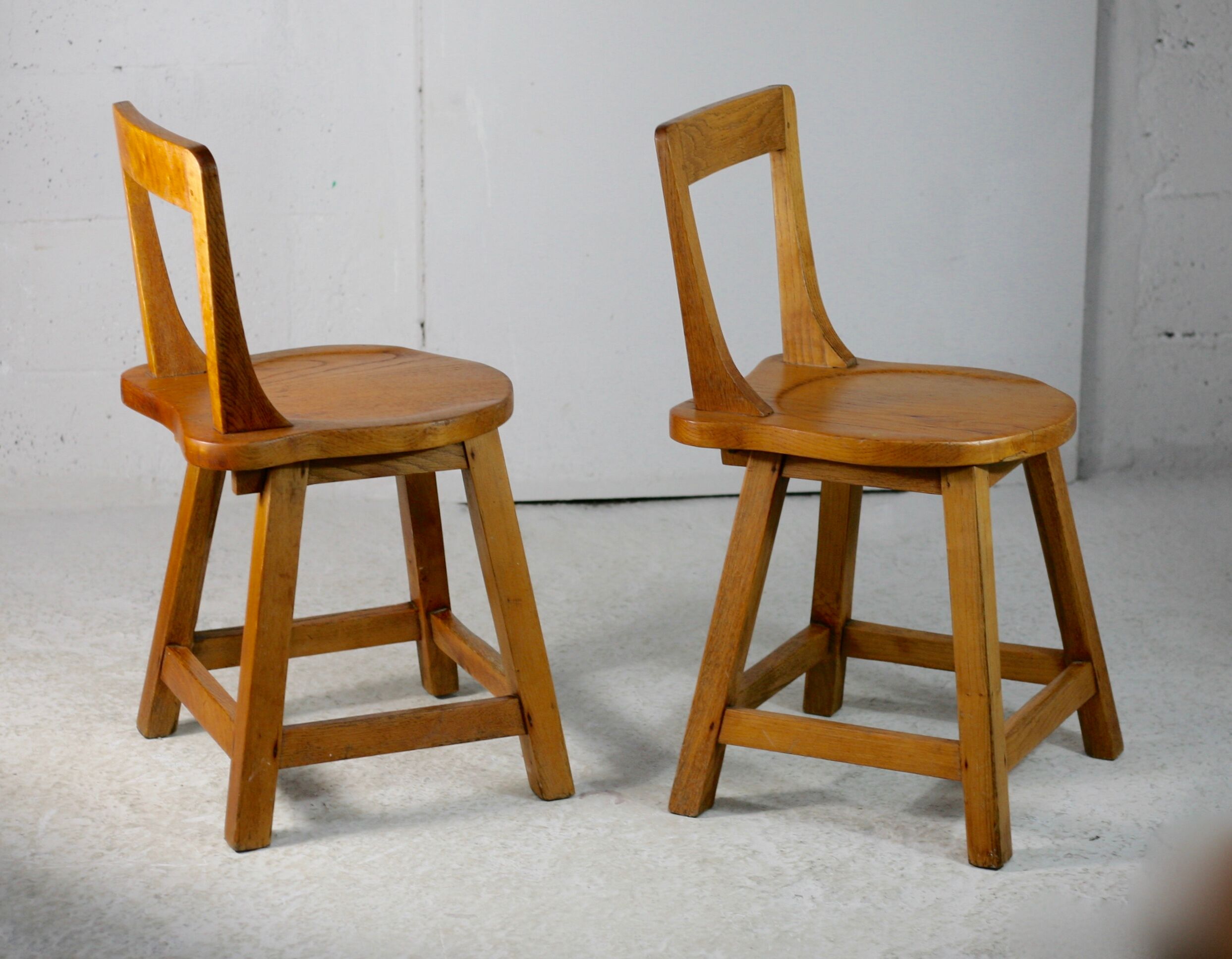 Pair of brutalist wooden back stools. France, circa 1960