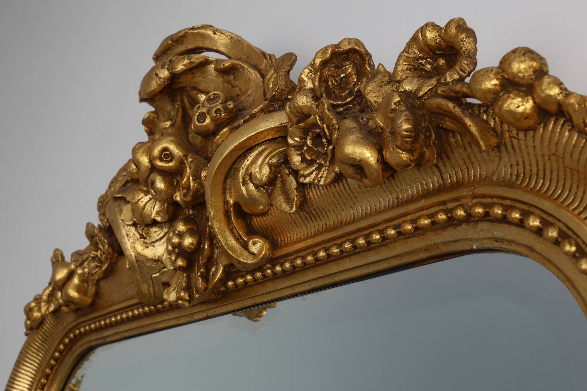 Baroque mantel mirror in carved wood and gilded plaster, France circa 1850.