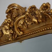Baroque mantel mirror in carved wood and gilded plaster, France circa 1850.