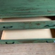 Vintage compass leg commode with a patina.