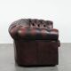 Classic cowhide Chesterfield sofa in English style with red/brown colours