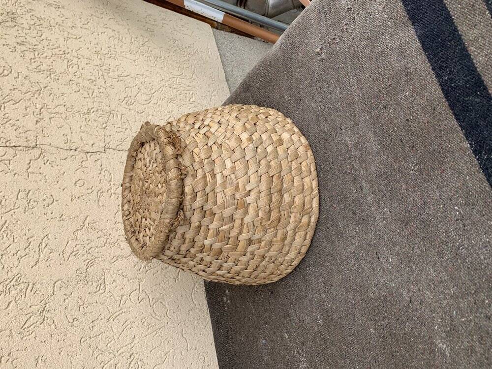 Brown woven wicker basket for collecting eggs — France, 1940s