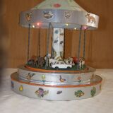 Old toy made of wood, aluminum and fabrics, animated and musical merry-go-round
