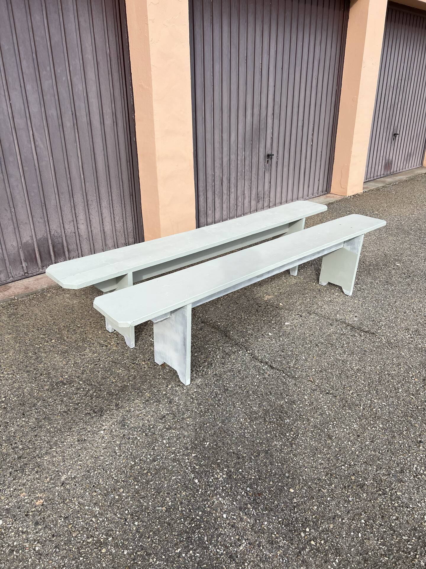 Pair of wooden benches painted white, French artisanal work.
