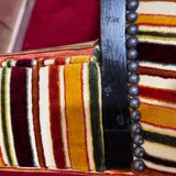 Art Deco armchair in multicolored striped fabric and its footrest