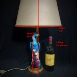 Large table lamp with earthenware peacock and beige silk lampshade