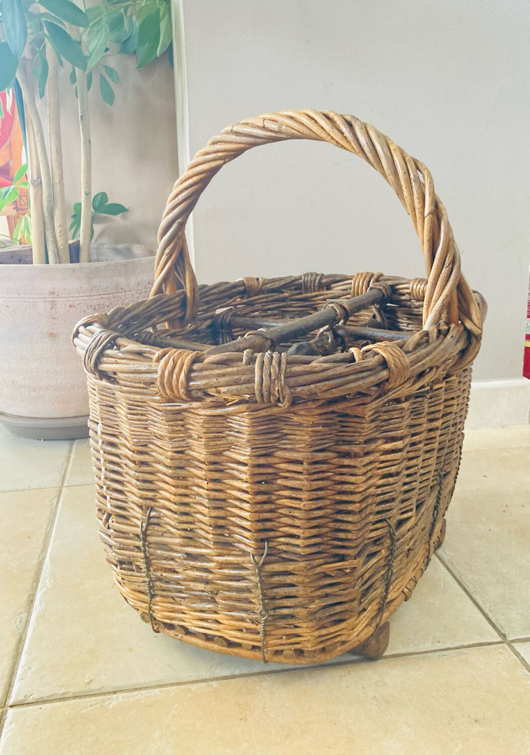 Wicker and hazel bottle basket from the early 20th century or possibly earlier.