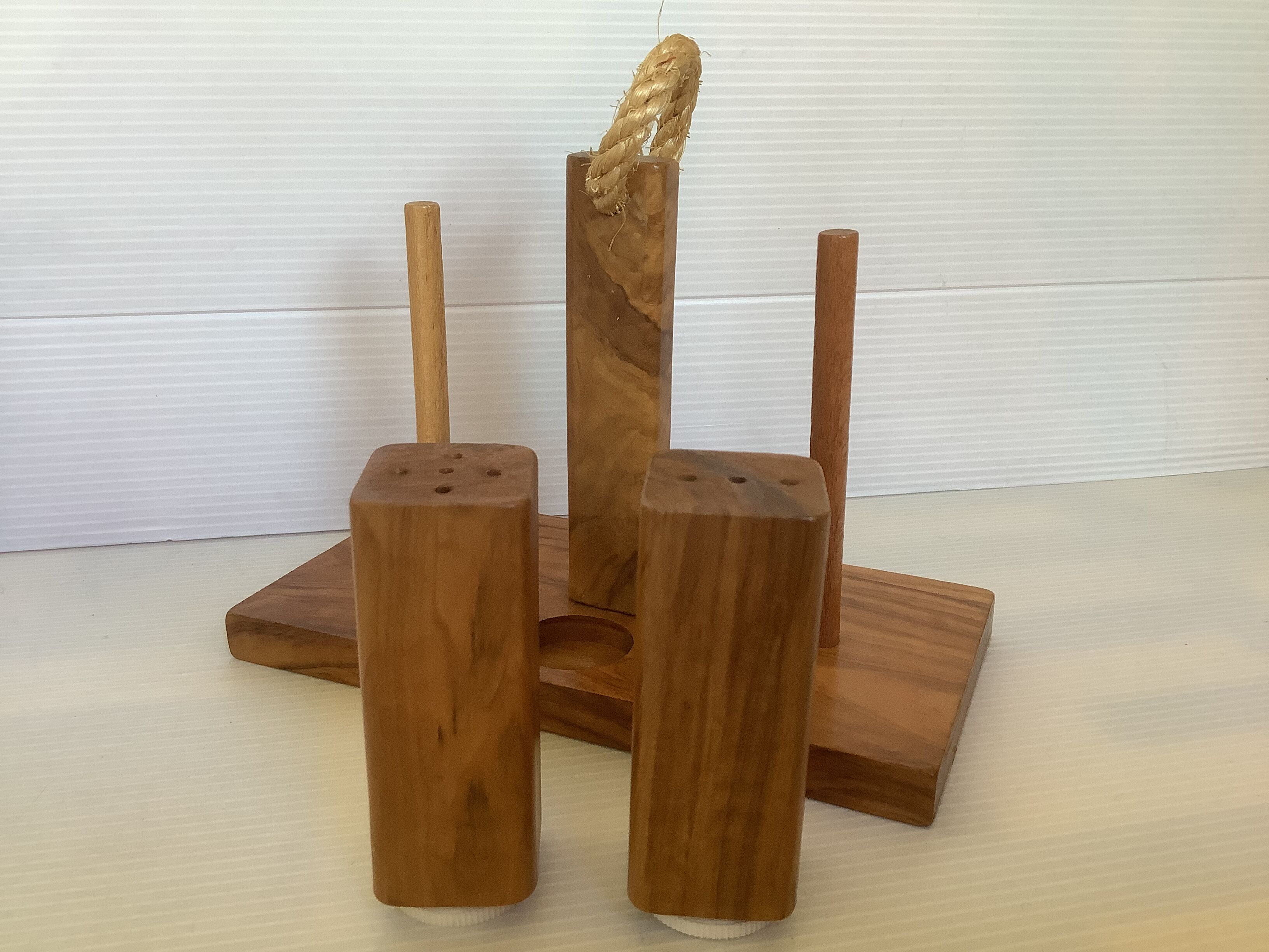 Six olive wood salt and pepper egg cups with their holder.