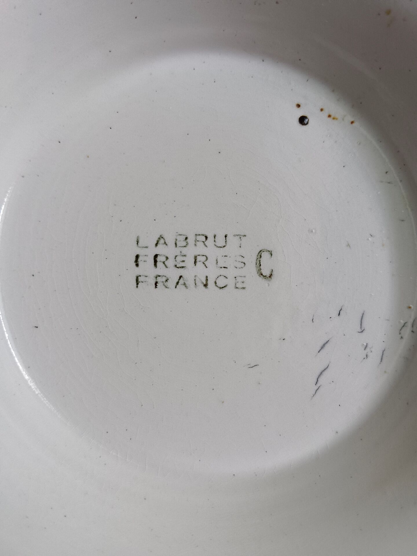 Old round footed plate signed Labrut brothers flowers