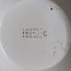 Old round footed plate signed Labrut brothers flowers
