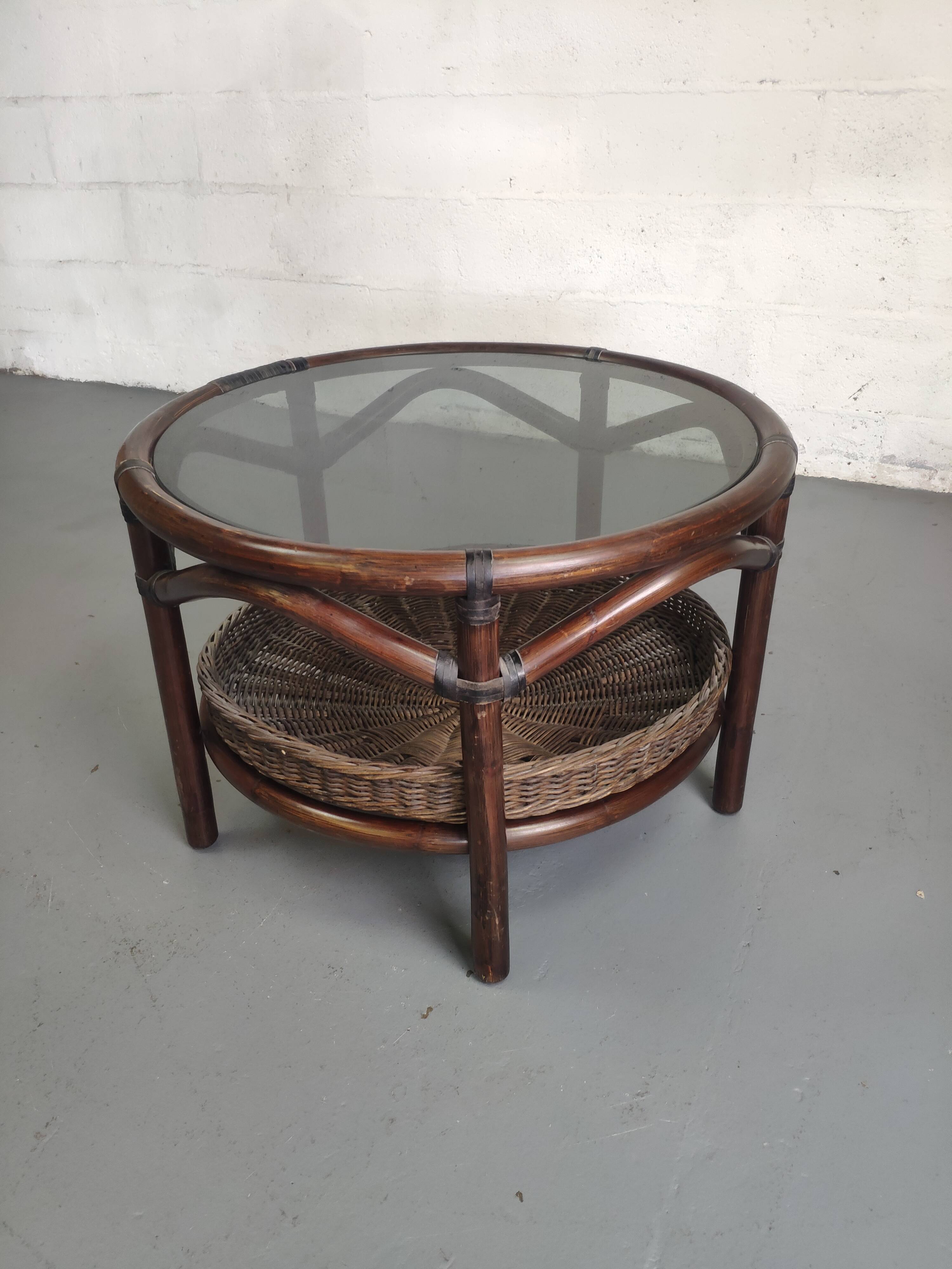 Vintage rattan coffee table with smoked glass top and rattan basket shelf