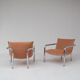 Pair of tubular armchairs in salmon velvet