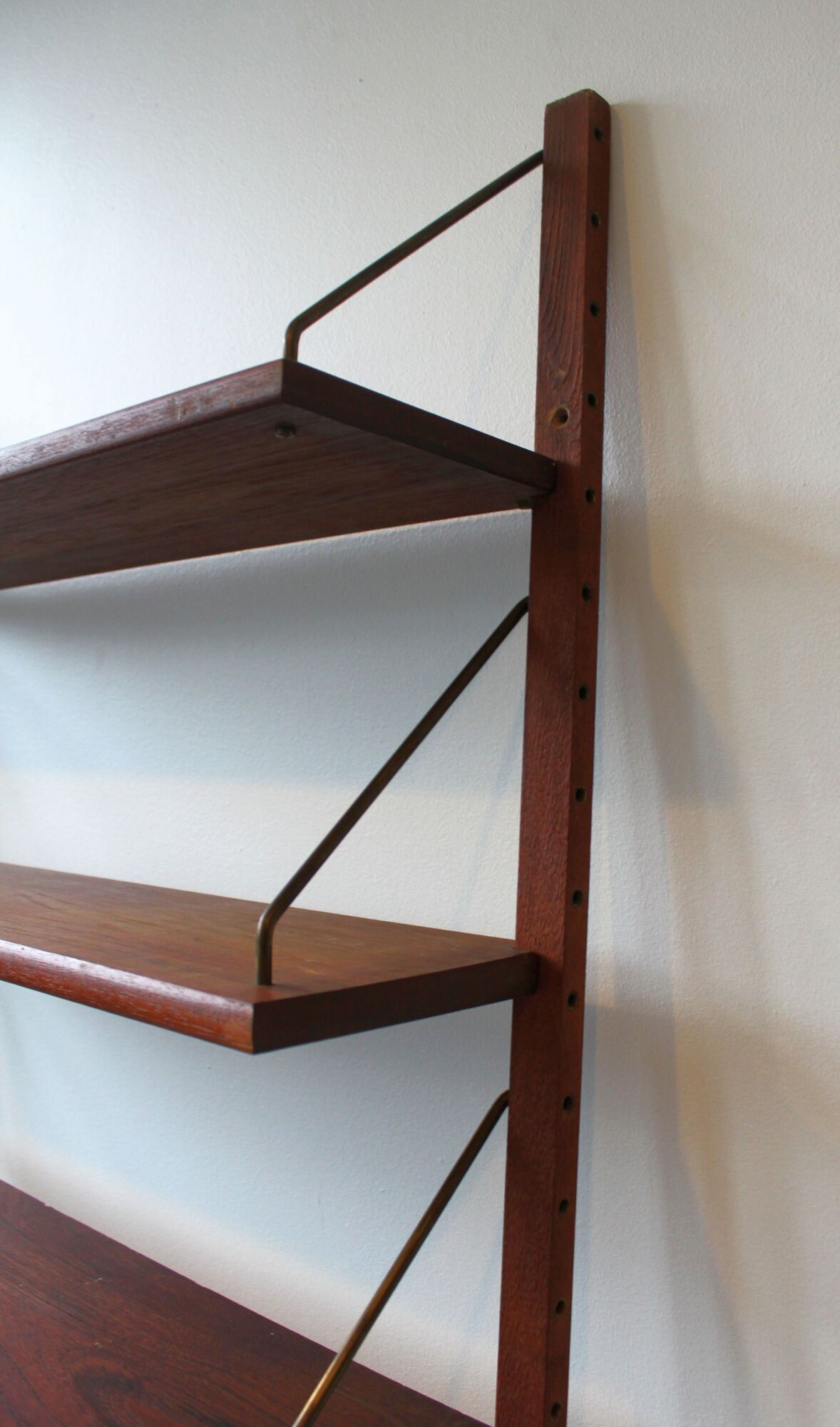 Teak and brass wall shelf by Poul Cadovius for Royal System, Denmark, 1960.
