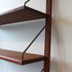 Teak and brass wall shelf by Poul Cadovius for Royal System, Denmark, 1960.