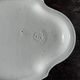 Antique oval-shaped white crackled faience plate with a scalloped edge.