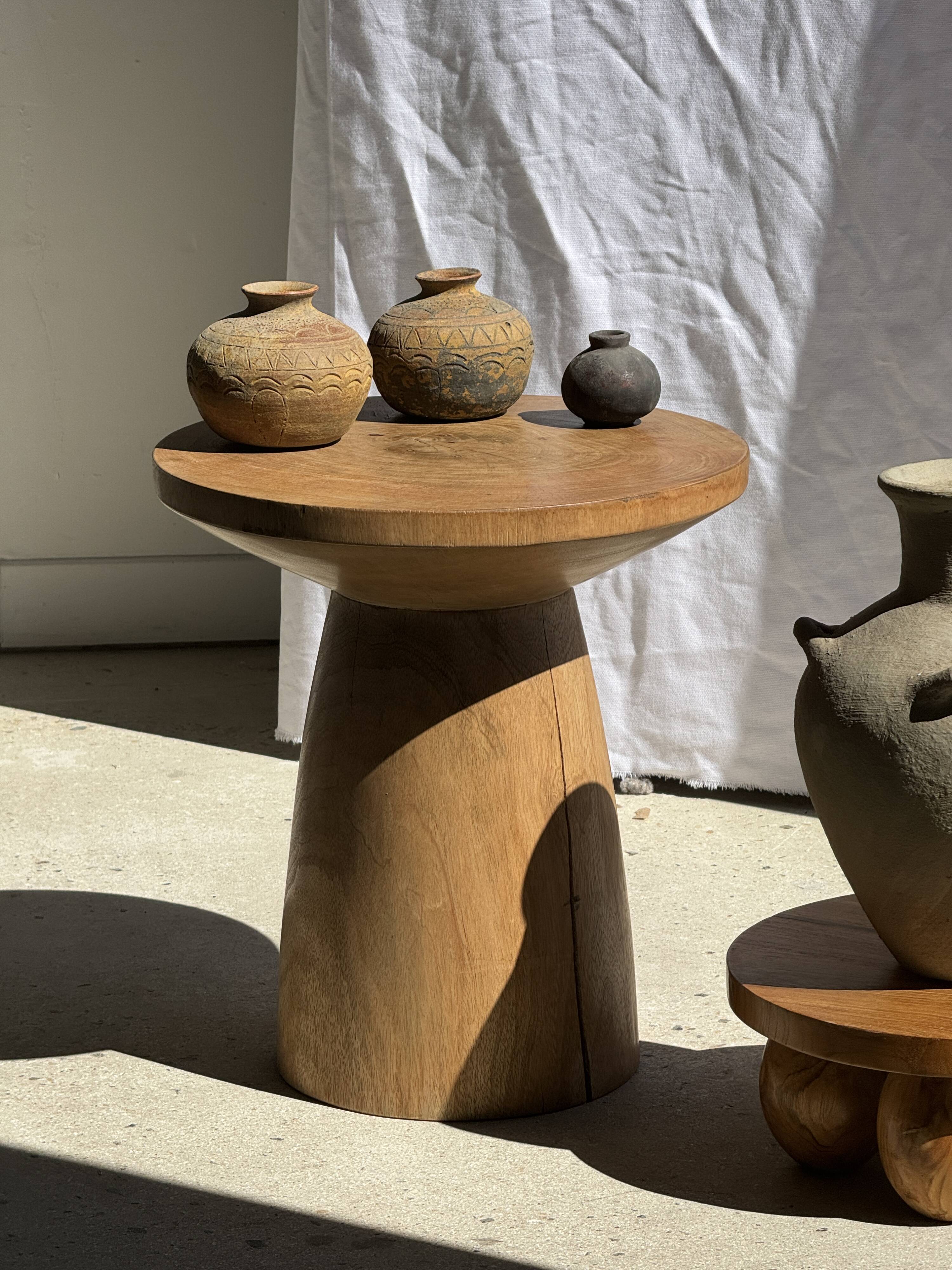 Natural solid mango side table (monoxyle) with conical legs.