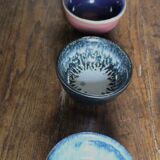 A set of 4 pottery bowls in coloured glaze.