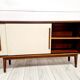 Mid-century teak sideboard with white synthetic doors.