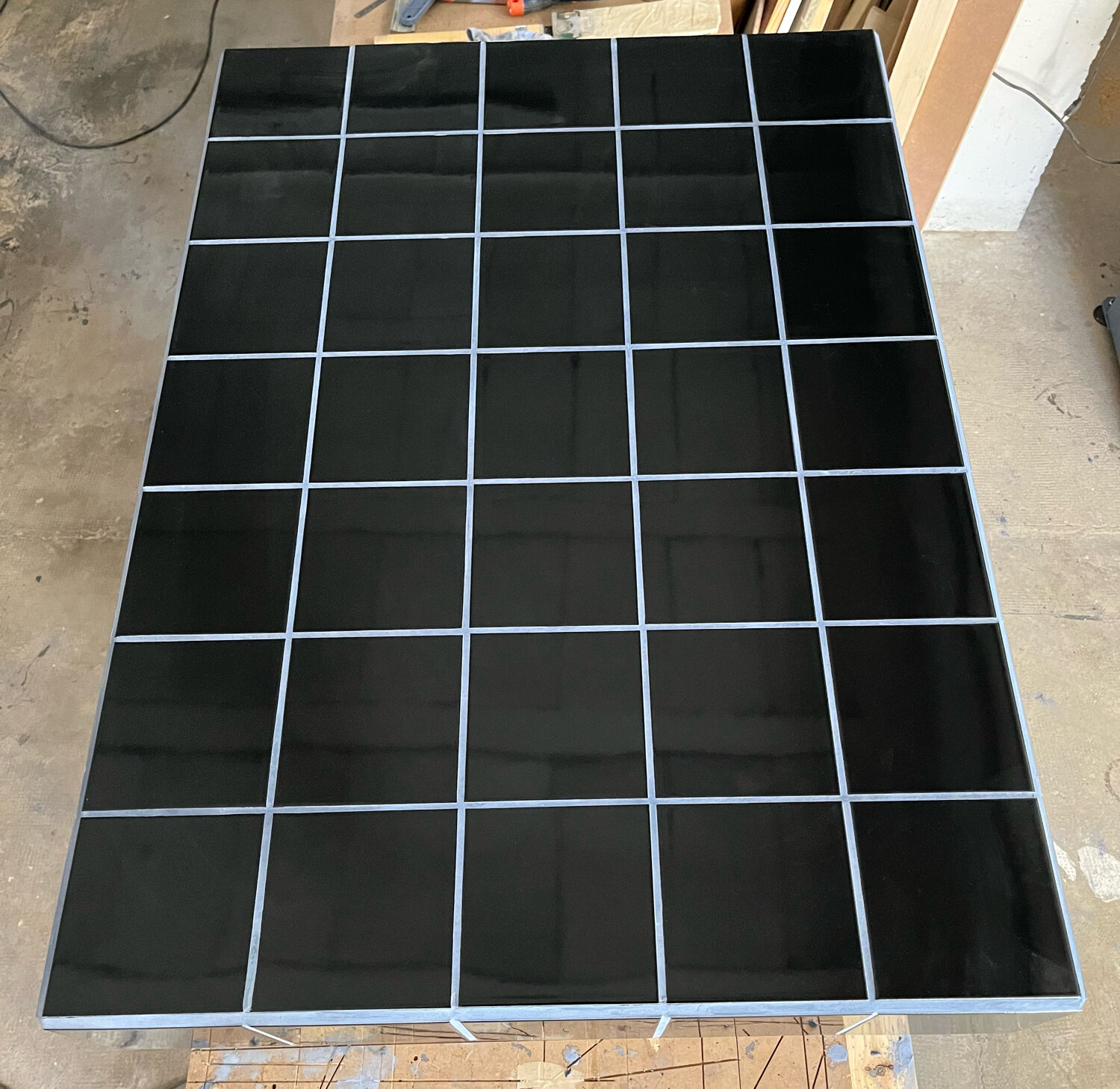 Black tiled coffee table and midnight blue grout