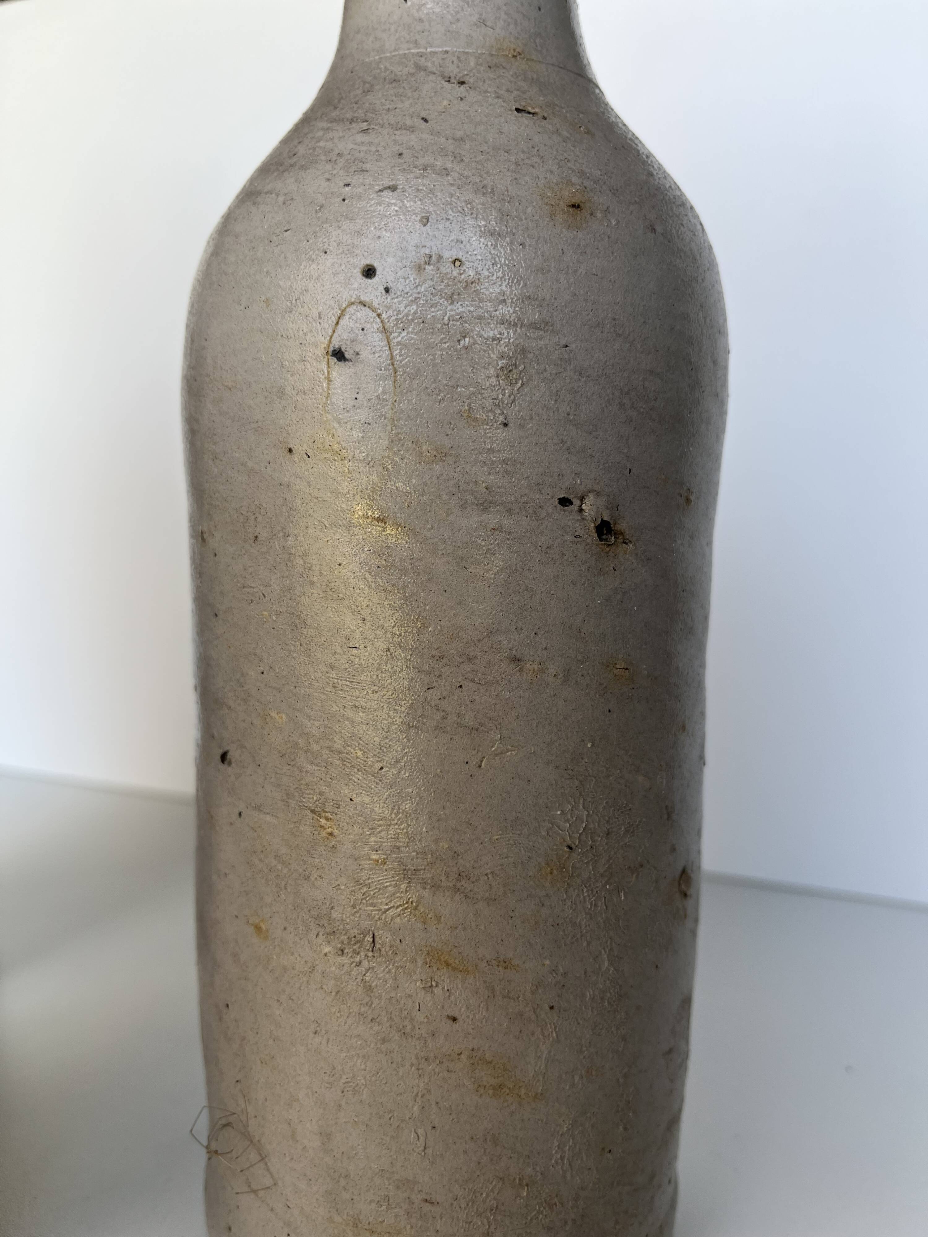 Trio of antique matte stoneware bottles