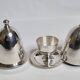 Deux coquetiers sous cloche en métal argenté avec plateau de présentation "Gombault", 28 cm