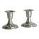 A pair of small silver-white metal candle holders.
