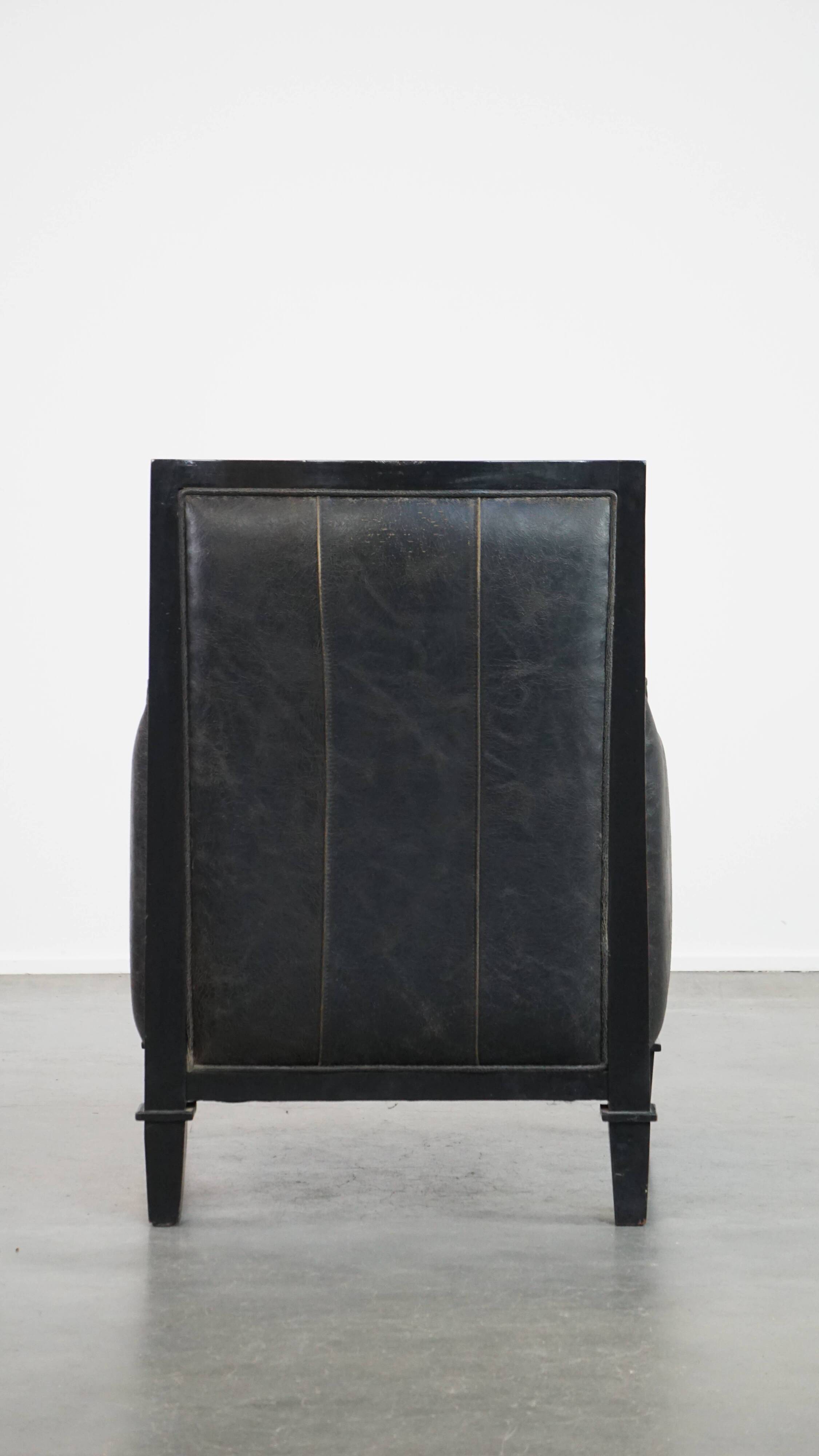 Armchair in black cowhide leather and wood with an Art Deco design