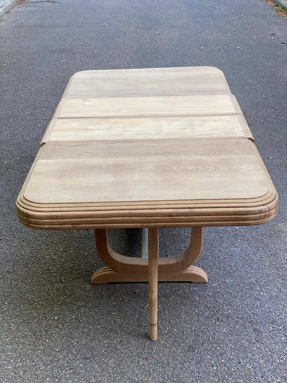 Art Deco dining table with a central pedestal, stripped in solid oak, with 2 extensions.