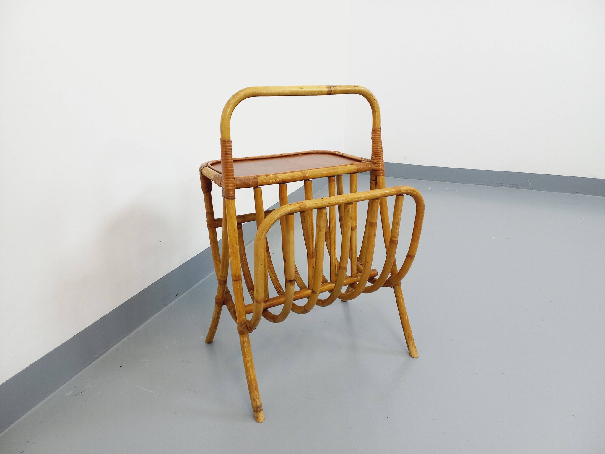 Side table with vintage rattan and wood magazine rack from the 60s