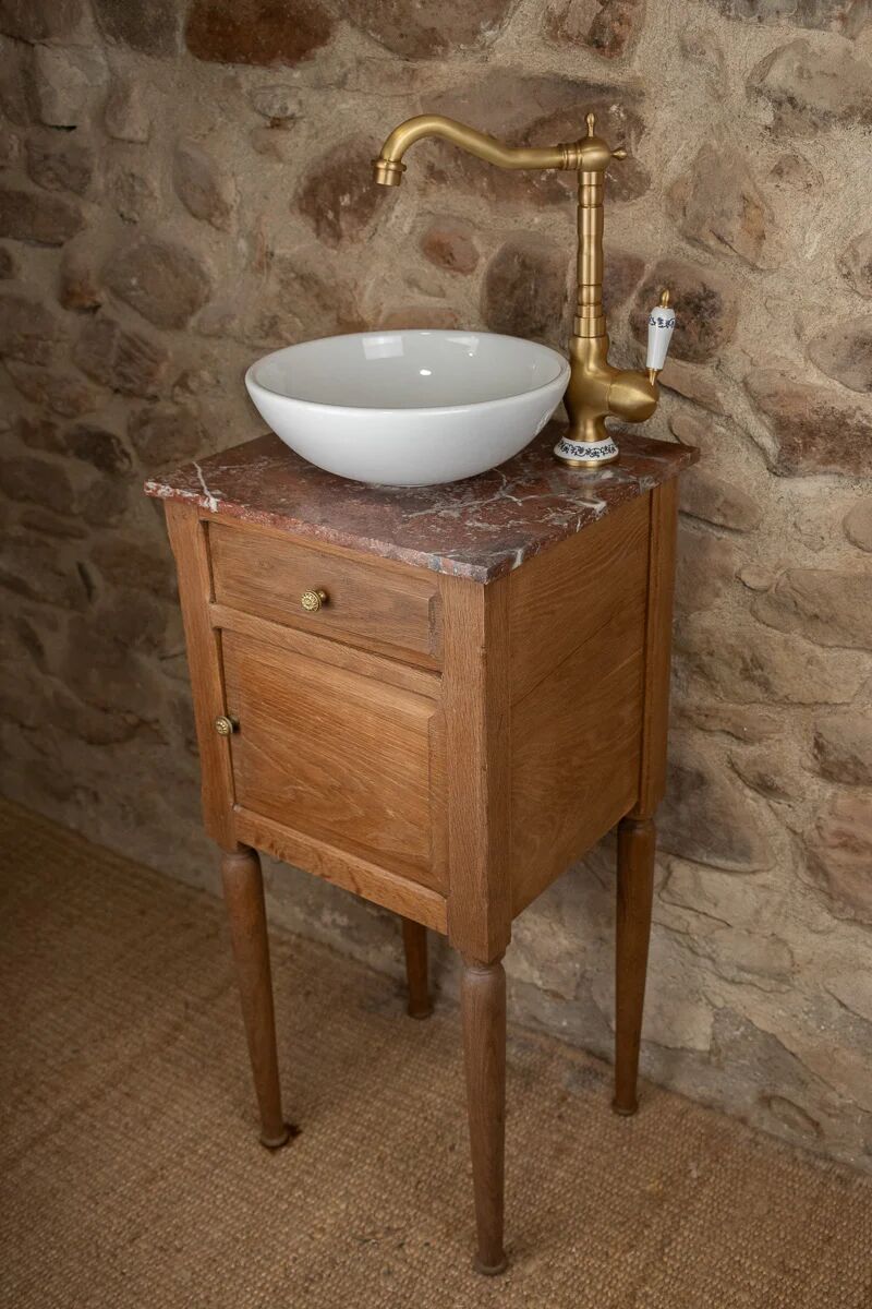 Small antique washbasin in wood and red marble.
