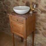 Small antique washbasin in wood and red marble.