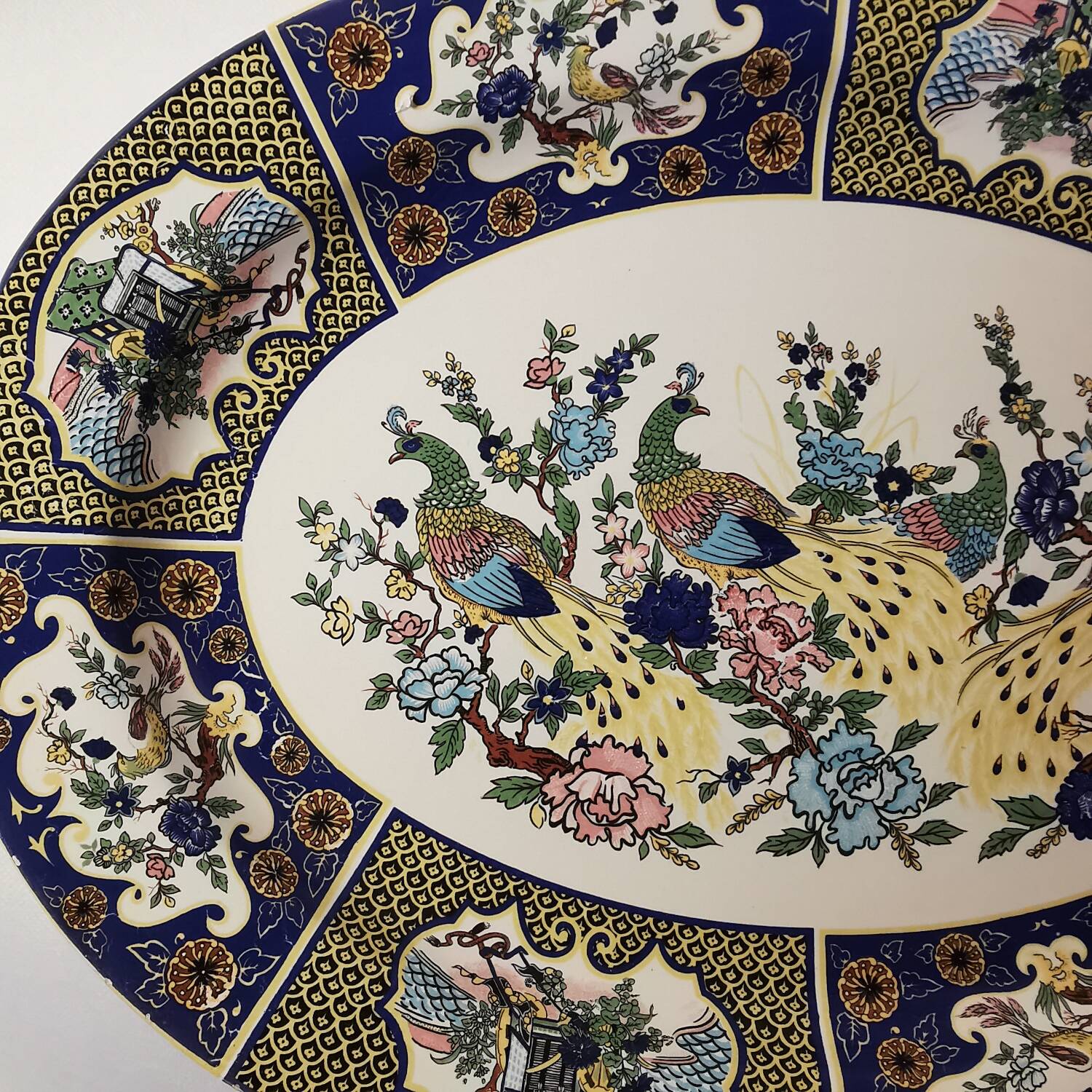Ceramic dish decorated with peacock folk art Asian motif