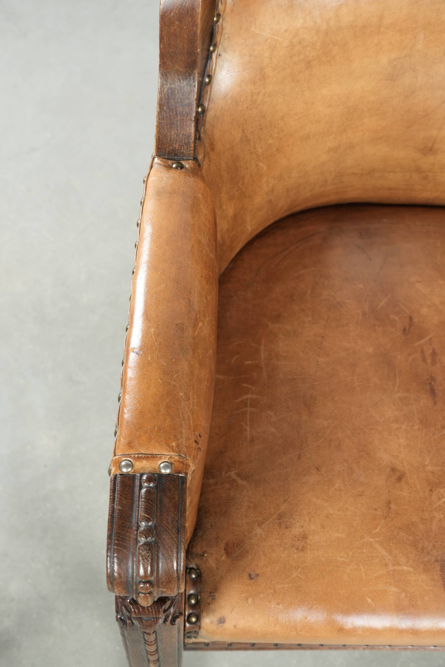 Antique armchair made of sheepskin and wood with decorative nails