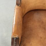 Antique armchair made of sheepskin and wood with decorative nails