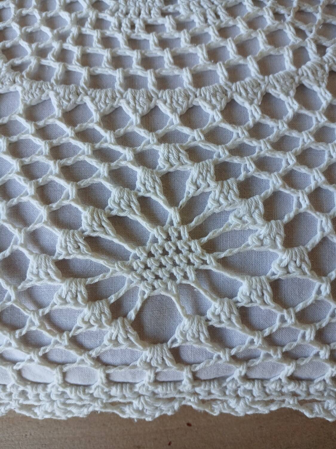 Cushion with white crochet cover