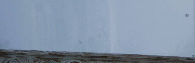 Chic and stylish antique mirror with carved wooden frame in whitewashed