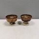 A set of ceramic candle holders in earthy colours.